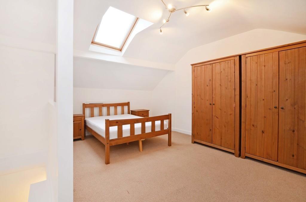 A bright and tidy double bedroom featuring a wo...