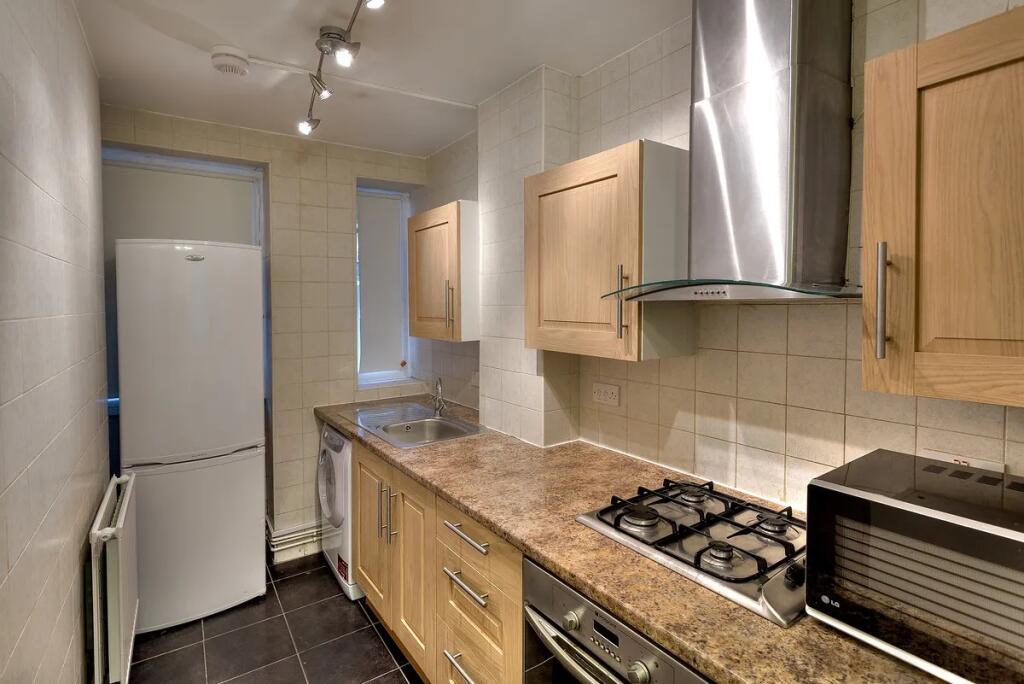 A well-maintained kitchen featuring wooden cabi...