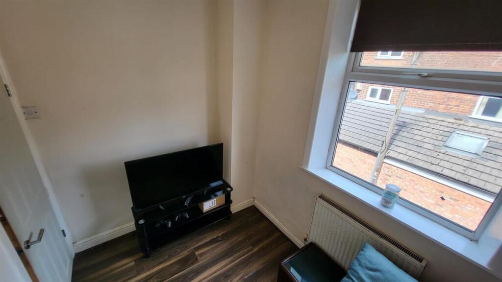 A cozy bedroom featuring a window that allows n...