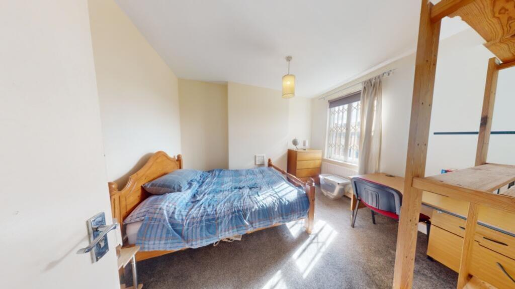 A spacious and inviting double bedroom with amp...