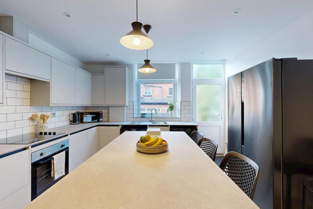 Bright and modern kitchen with ample natural li...