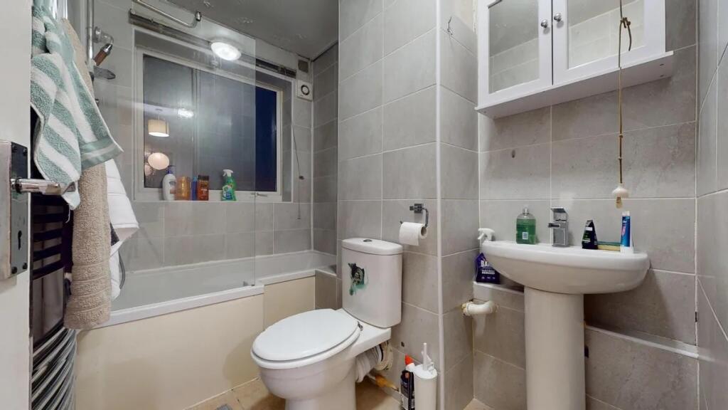 A modern bathroom suite featuring a bath with s...