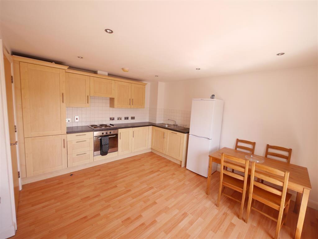 Bright and clean kitchen with wooden cabinetry,...