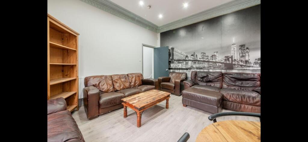 Comfortable communal lounge with multiple leath...