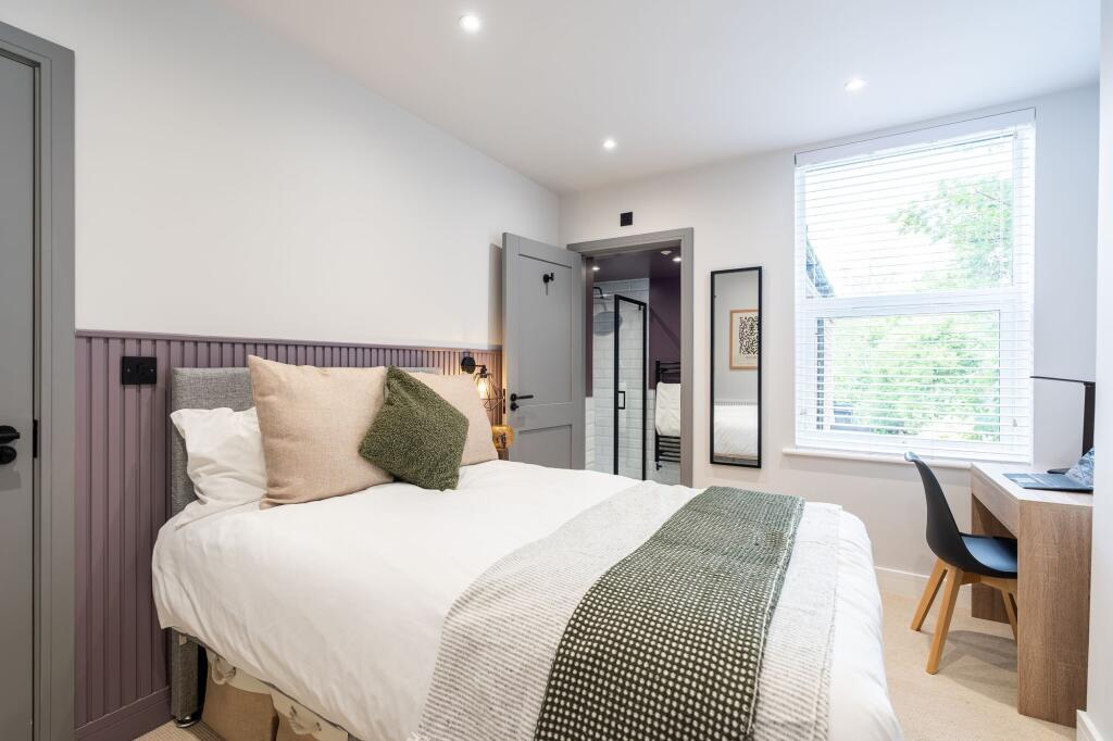 Bright and stylish double bedroom featuring a c...