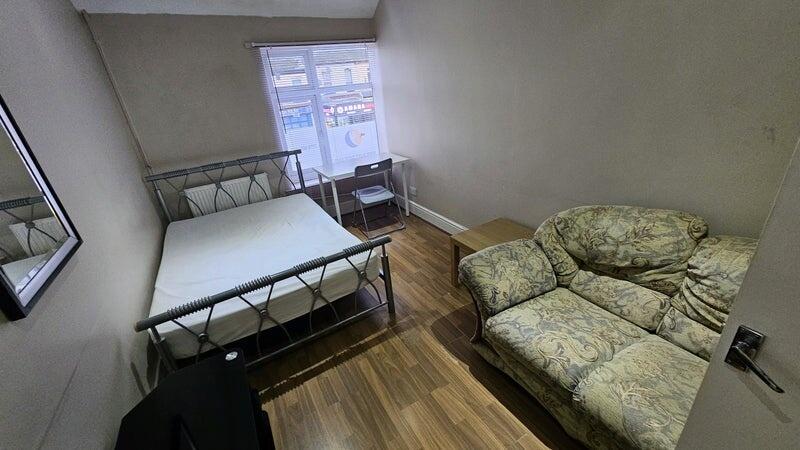 A cozy double bedroom featuring a double metal-...