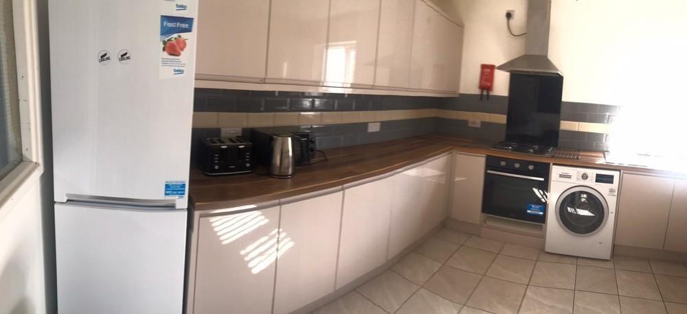 Bright and modern kitchen featuring ample count...