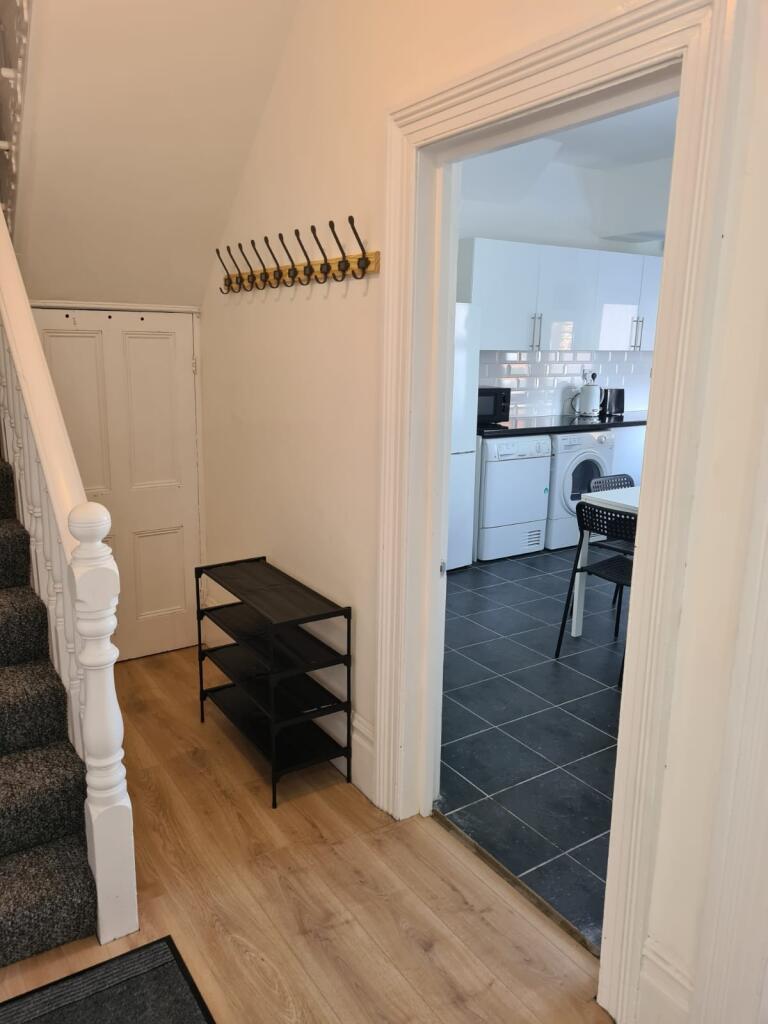 Bright and tidy hallway featuring light wooden ...