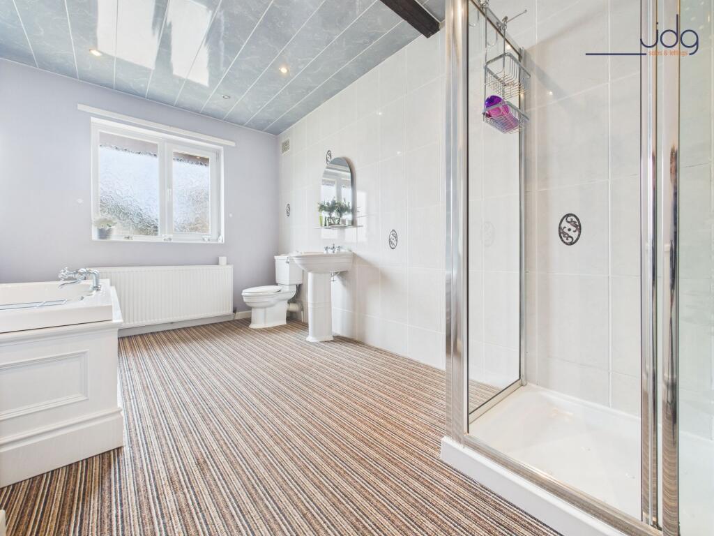 Four-piece suite with a Jacuzzi-style bath and separate shower