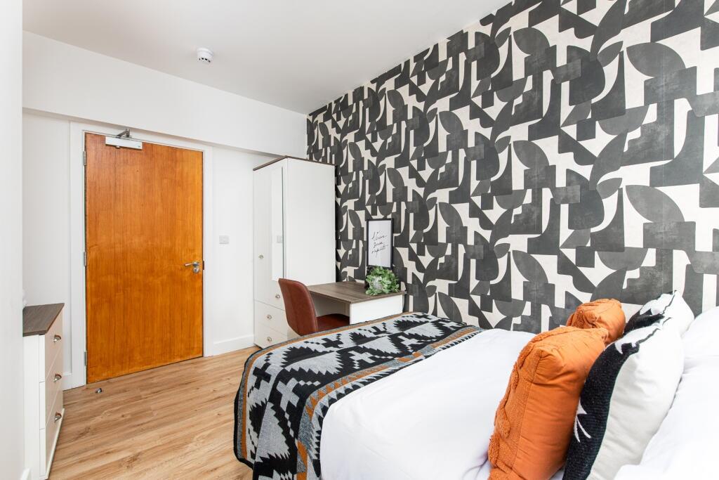 A stylish double bedroom featuring contemporary...
