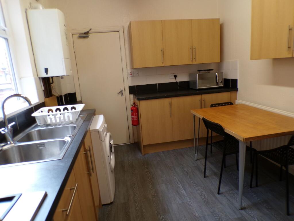 A modern, well-maintained kitchen with wooden c...