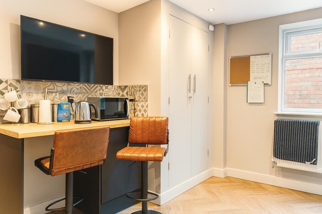 Bright and modern kitchen area featuring a larg...