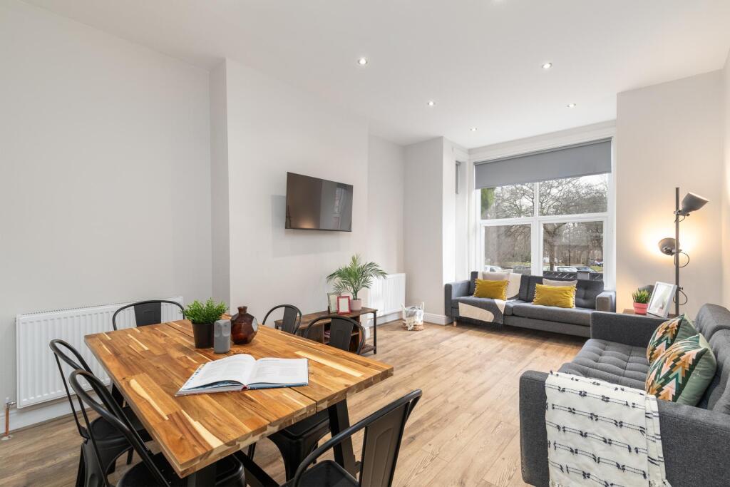 A bright, spacious living room featuring large ...