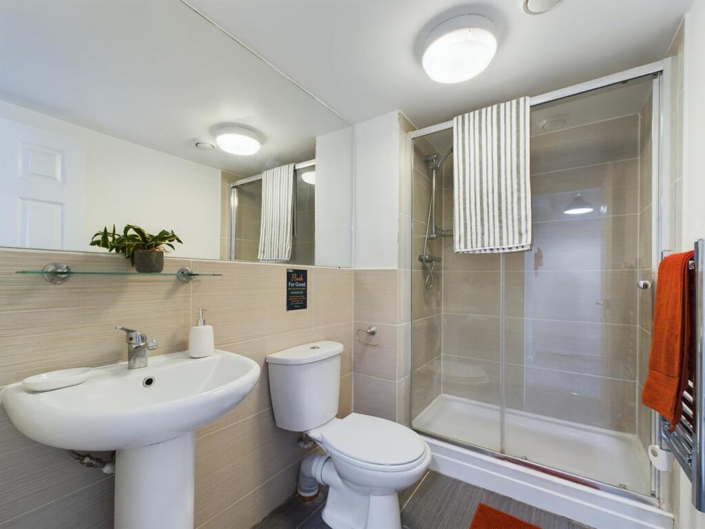 A modern and immaculate bathroom featuring a sp...