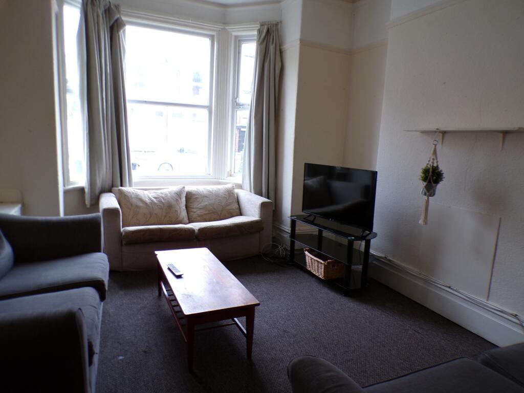 A cozy living room with ample natural light, pe...