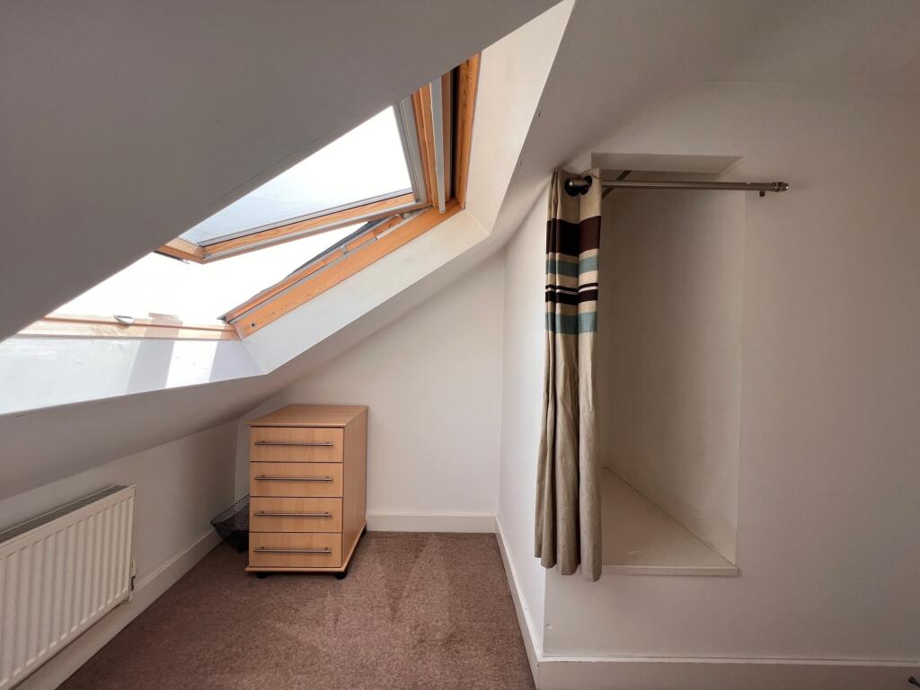 Bright single bedroom with a skylight window pr...