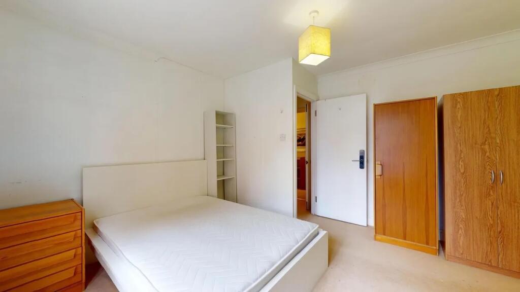 Bright and tidy double bedroom featuring a comf...