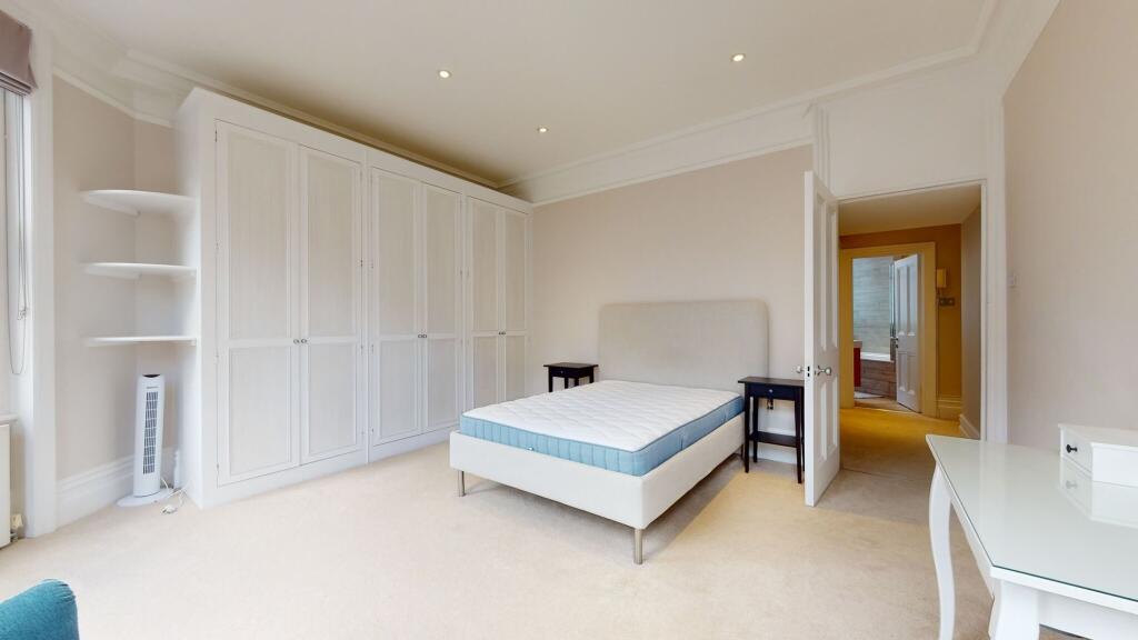 Bright and spacious bedroom featuring a large d...