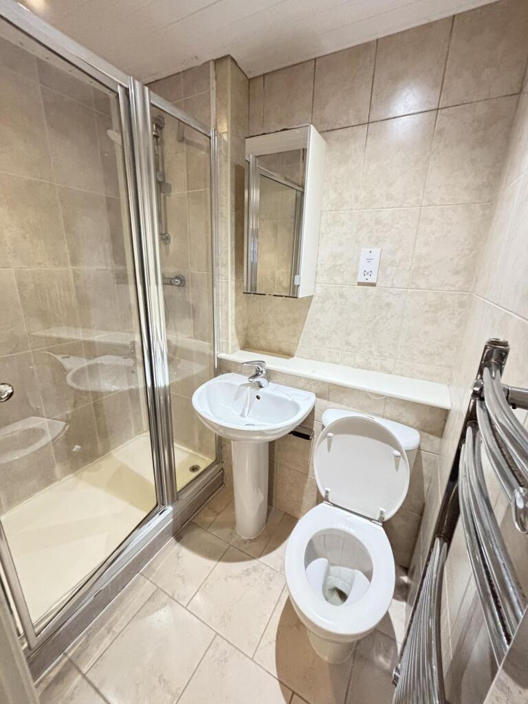 A clean and modern bathroom with a shower enclo...