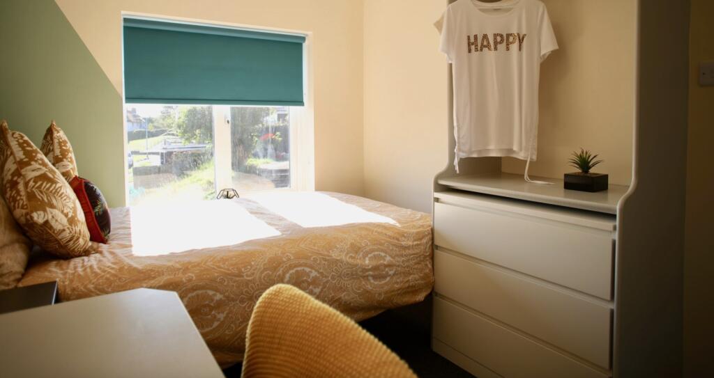 This inviting double bedroom features a comfort...