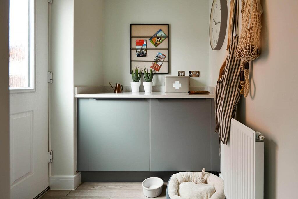 An adjoining utility area offers space for laundry appliances