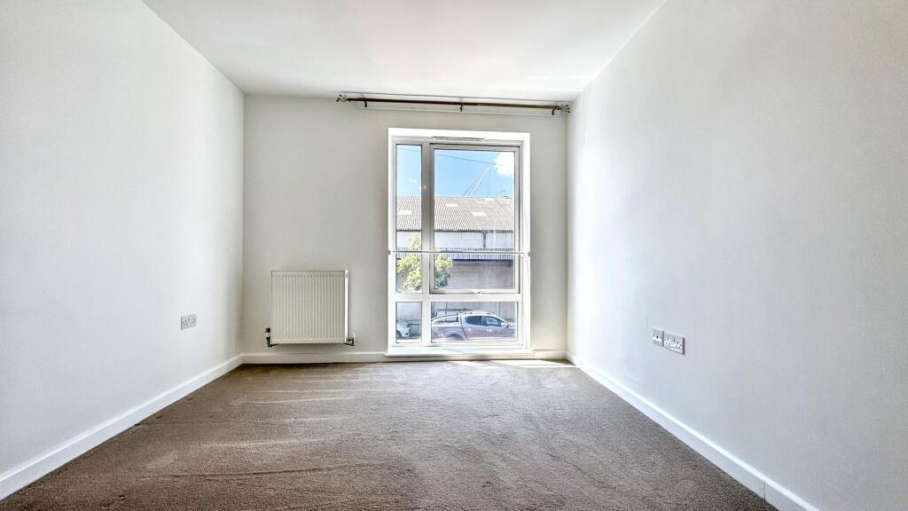 A bright and clean double bedroom featuring a l...
