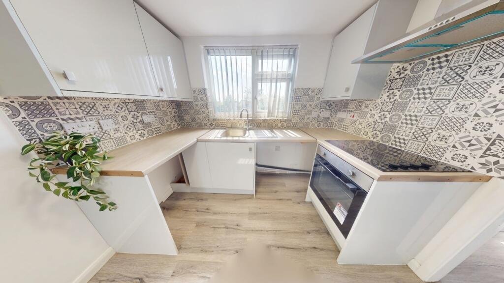 Bright and modern kitchen featuring a stylish t...