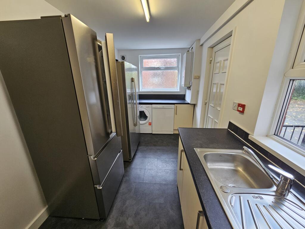 A clean, modern kitchen featuring stainless ste...