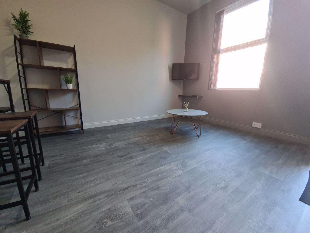 Bright living room featuring modern flooring an...