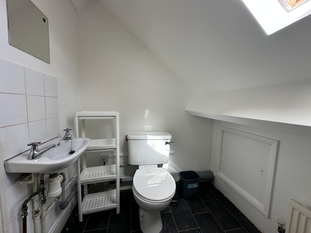 Bright and clean single toilet with modern fixt...