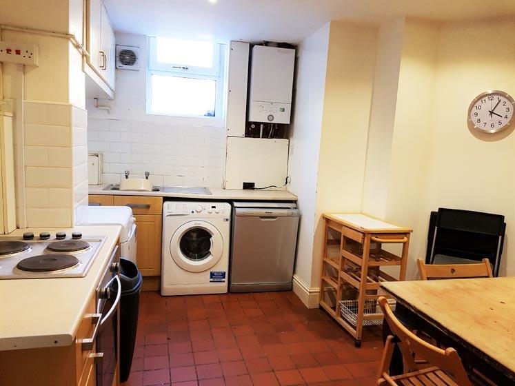 A well-lit kitchen with practical appliances an...