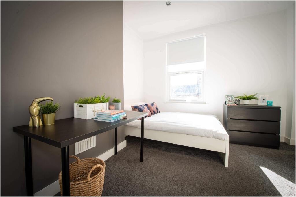Bright and inviting master bedroom with a comfo...
