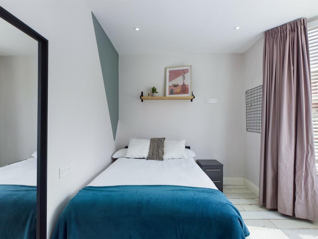 A spacious and modern double bedroom featuring ...