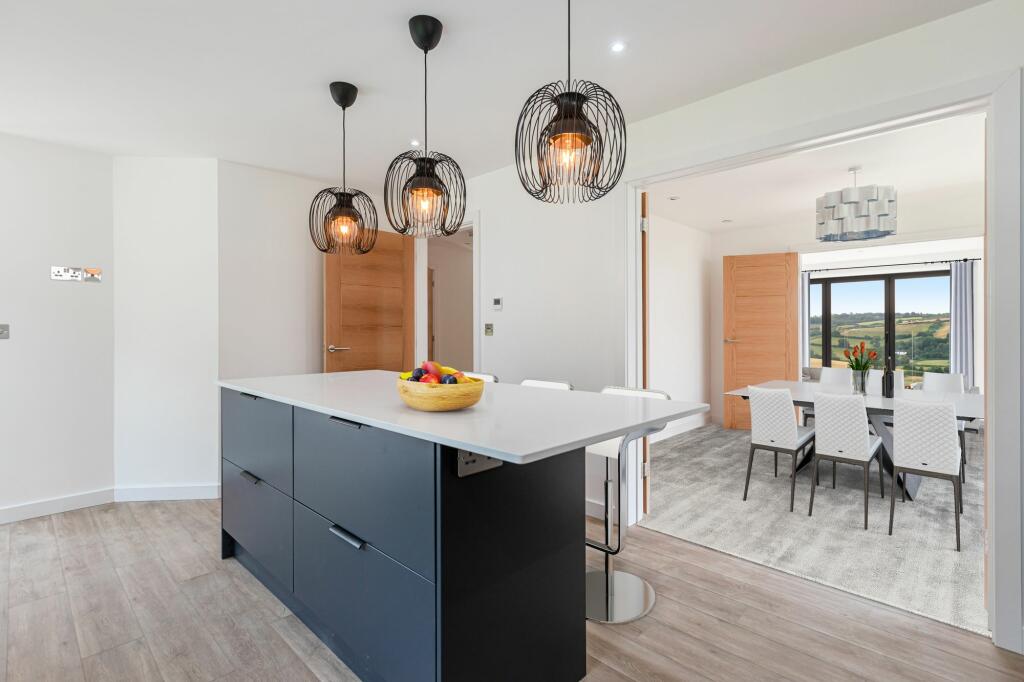 Kitchen into dining then living room