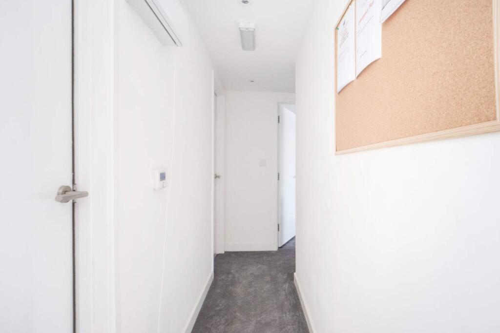 A bright and welcoming hallway featuring modern...