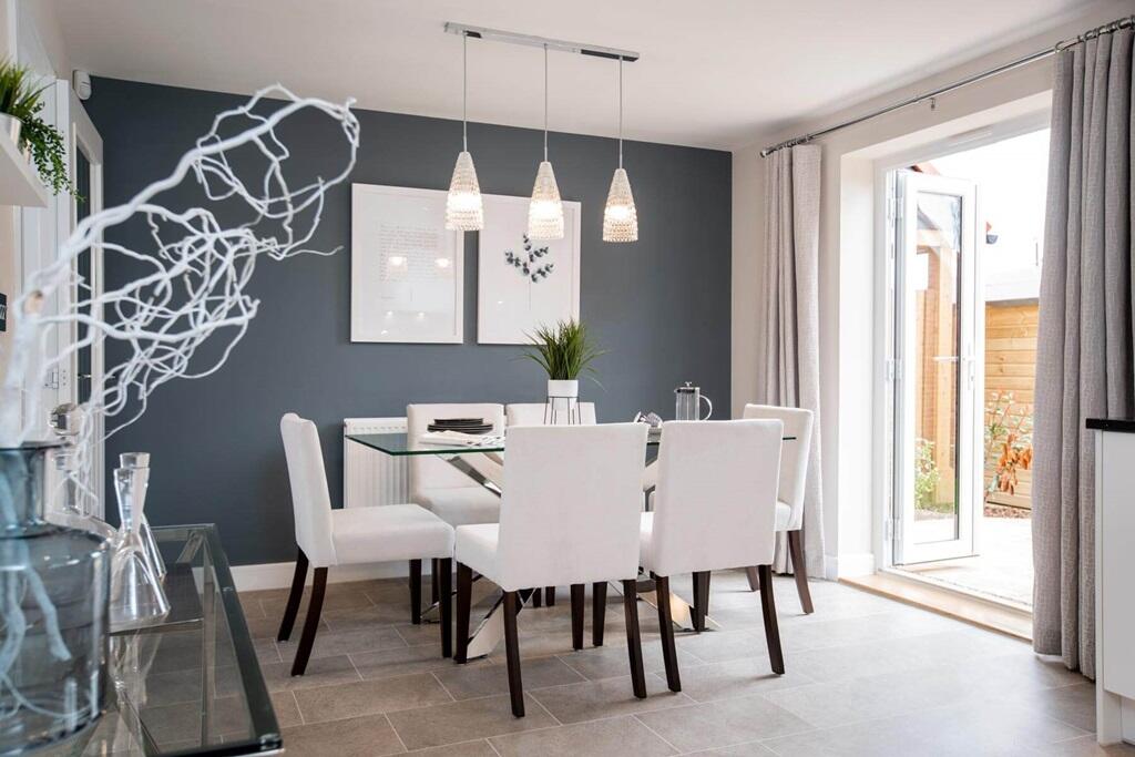 The dining area leads through double doors to the garden