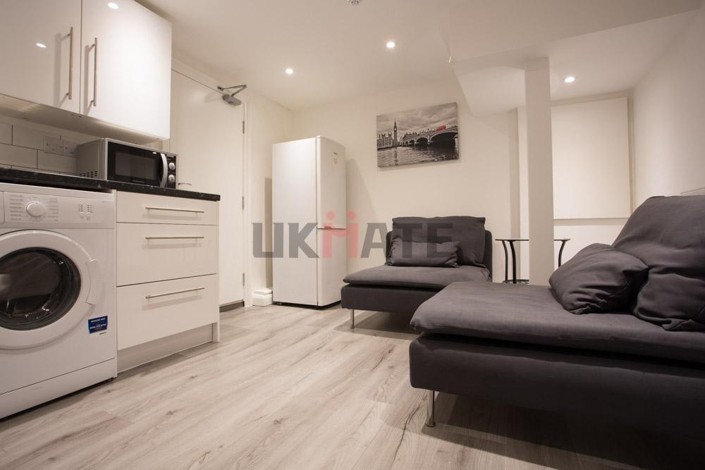 A modern, well-lit living room featuring comfor...