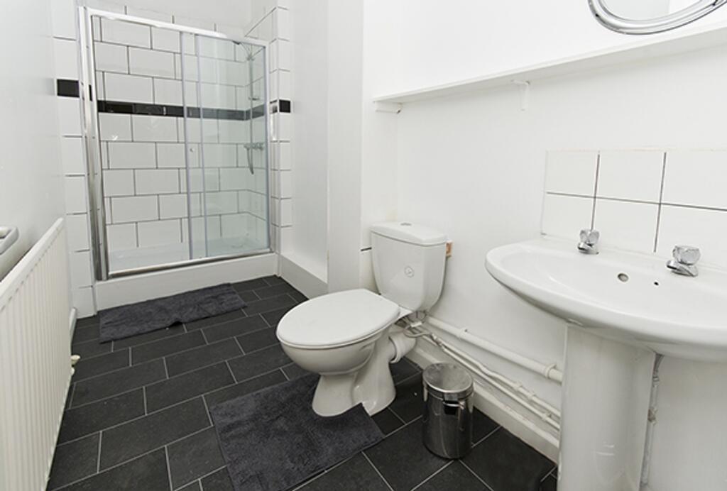 A modern and tidy bathroom featuring a sleek sh...