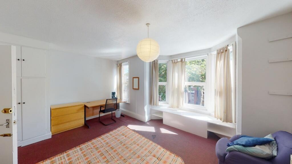 Bright and spacious master bedroom featuring a ...