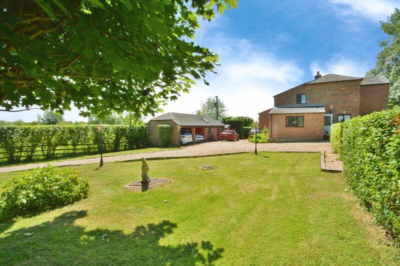 Front garden, driveway, house, and an...