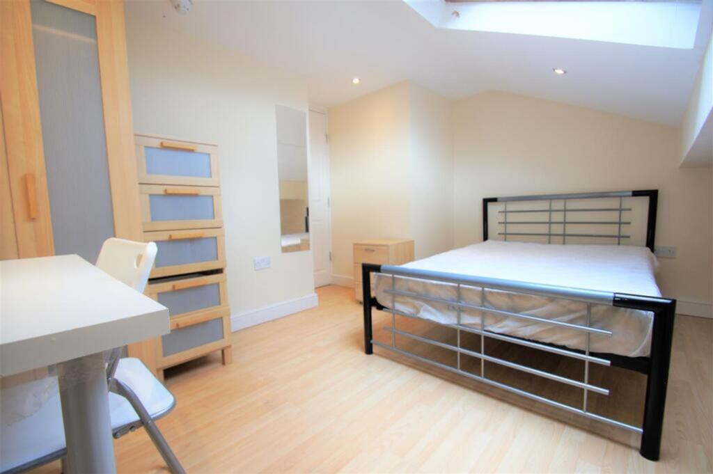 Bright and inviting double bedroom featuring sl...