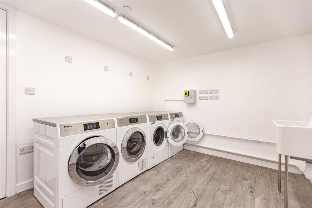 Bright and spacious laundry room featuring mult...