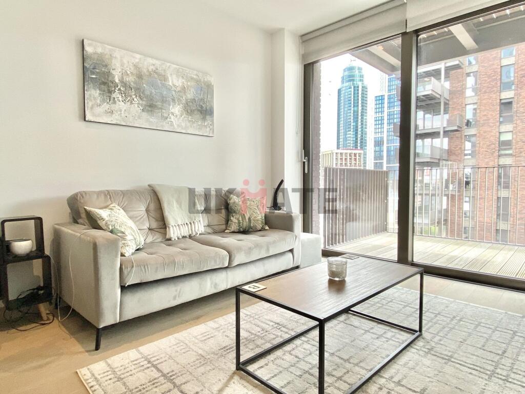 Modern, well-lit living room with a comfortable...
