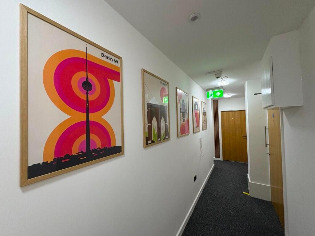 A clean, well-maintained hallway featuring mode...