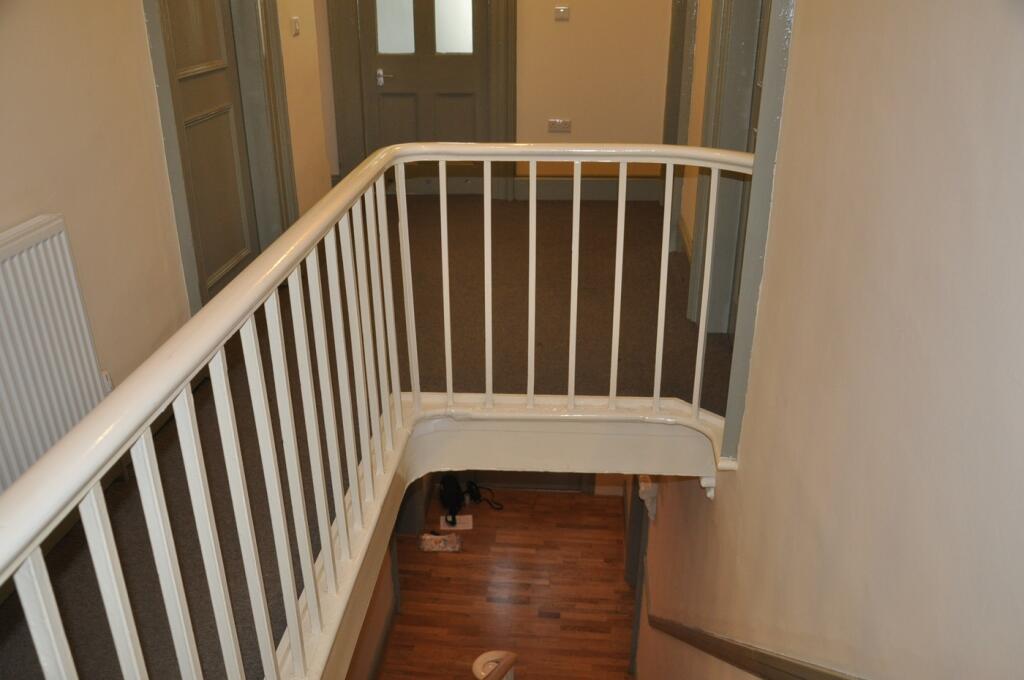 A tidy and well-maintained hallway with a welco...