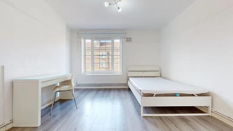 Bright and clean single bedroom featuring a lar...