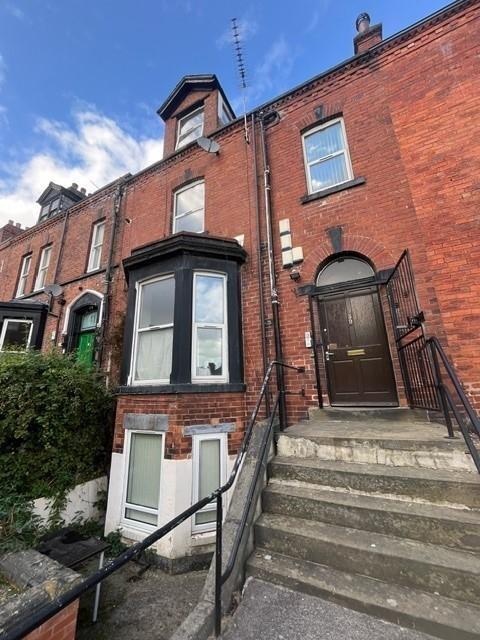 Attractive red-brick terraced house façade with...