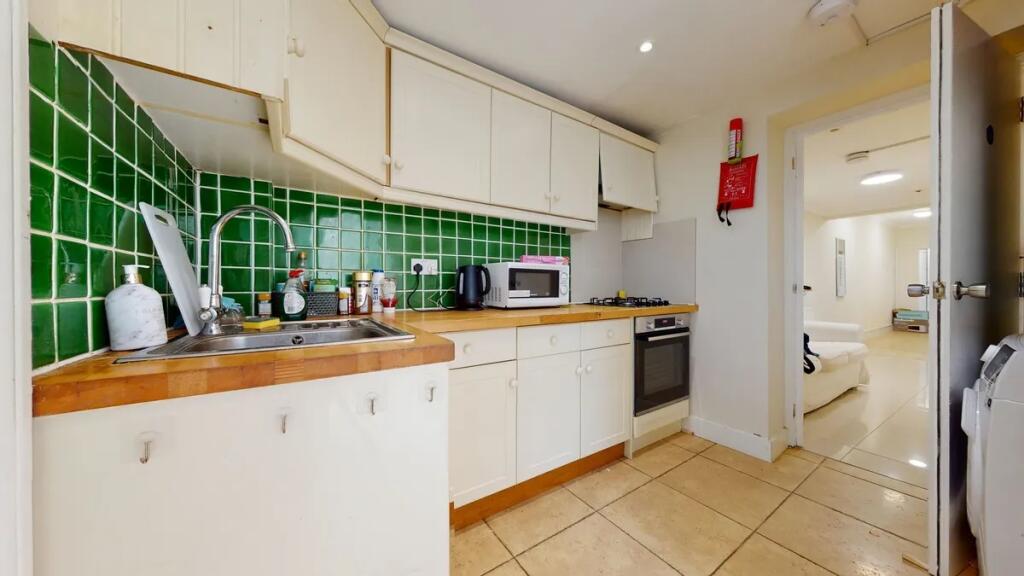 A bright and clean kitchen space featuring clas...