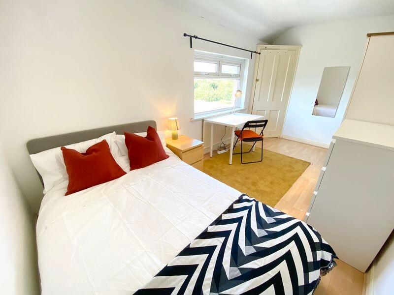Bright and tidy double bedroom featuring a comf...
