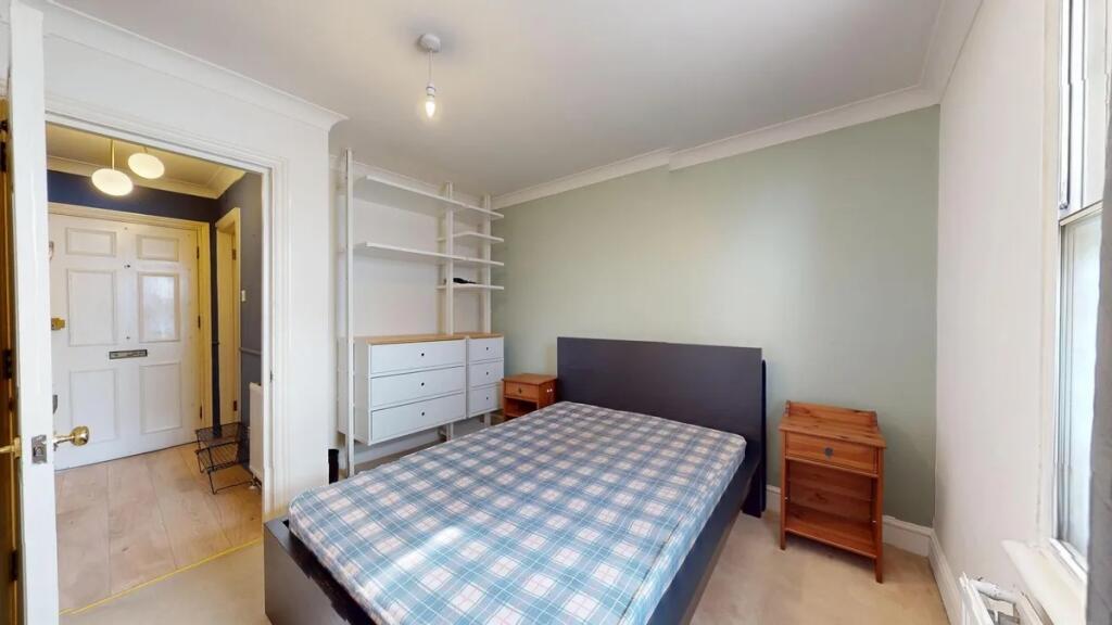Bright and tidy double bedroom featuring a larg...